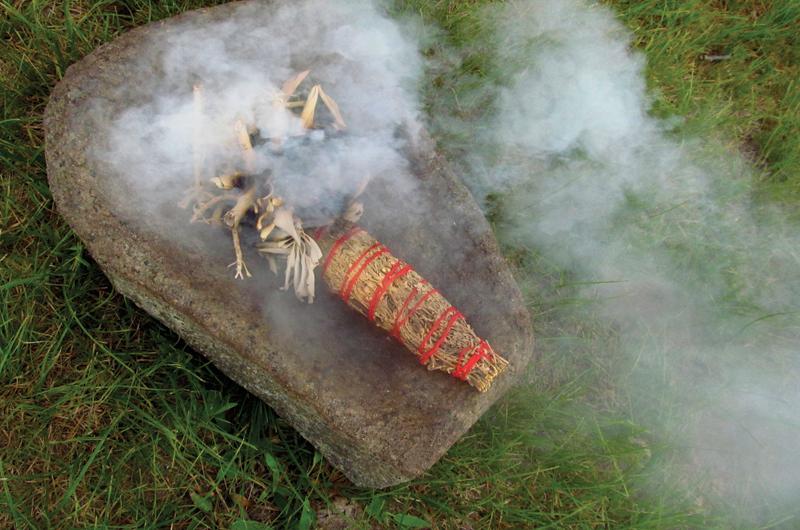 Sacred smoke from sage is used to cleanse the circle at the annual gathering.