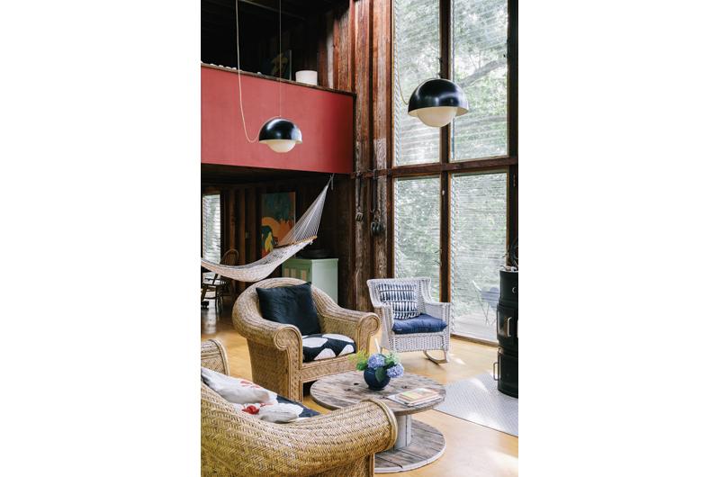 Floor-to-roofline jalousie windows allow sunlight to flood the interior.