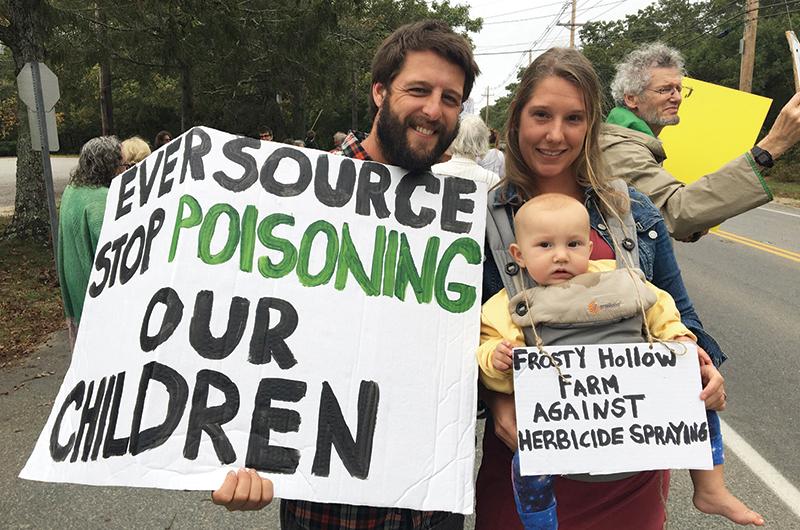 Keith and Clarissa Crossland, with son Hezekiah, at a protest outside the Vineyard Haven Eversource building in the fall of 2017.