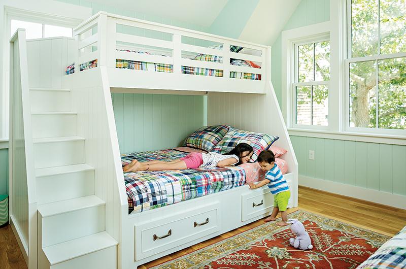 The interior of the home features Swedish furnishings and soft blues, greens, pinks, and yellows – a muted version of the striking exterior color palette.