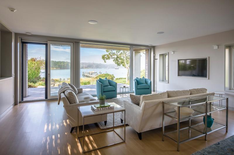 The great room’s large windows offer sweeping views of Lake Tashmoo.