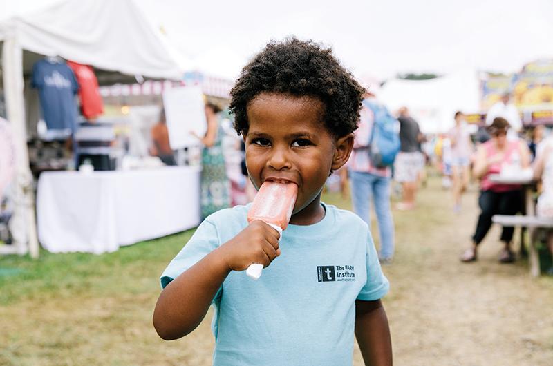 A favorite part of the fair? The food, like the strawberry-cream popsicle enjoyed by Sam Omiyale-Press.