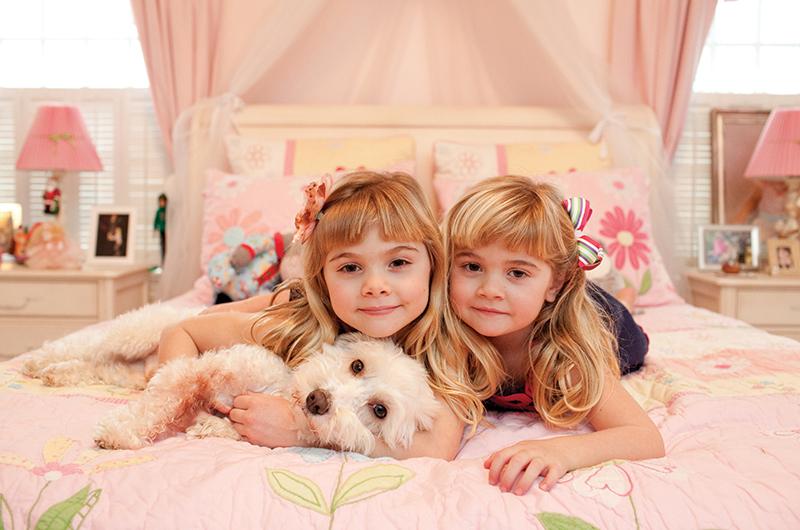 The Conover girls and dog at home in their bedroom.