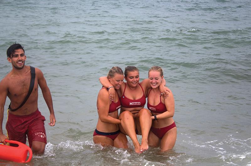 From left: Alex Vasiliadis, Jess Sonia, and Liv Myrick carry Sarah Alexander to safety.