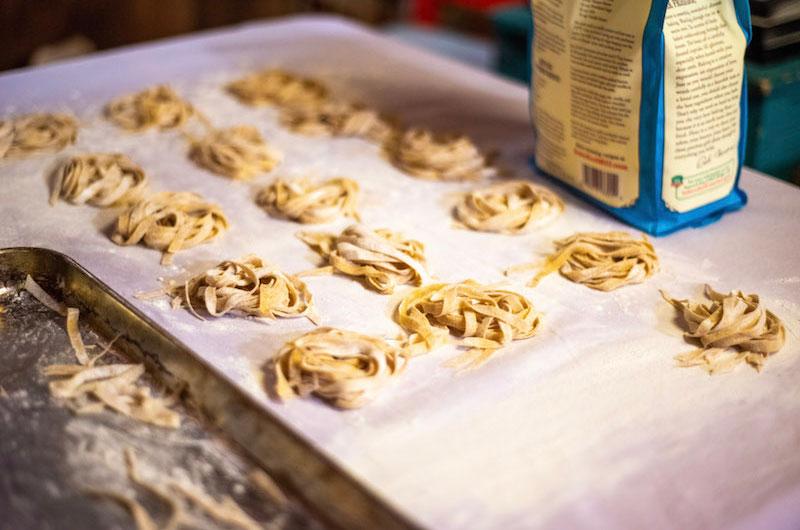 Twirl the pasta into nests and let dry for 3 to 7 days, depending on the humidity. Covering a large surface area with dish towels or bed sheets is helpful.