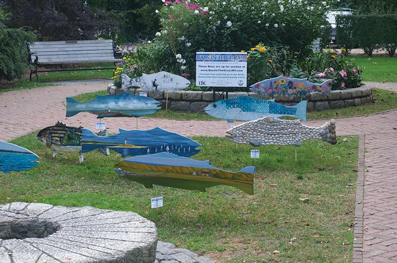 Island artists such as Kenneth Vincent (foreground), Traeger di Pietro (back left), and Deborah T. Colter (middle right) create the fishy works of art.