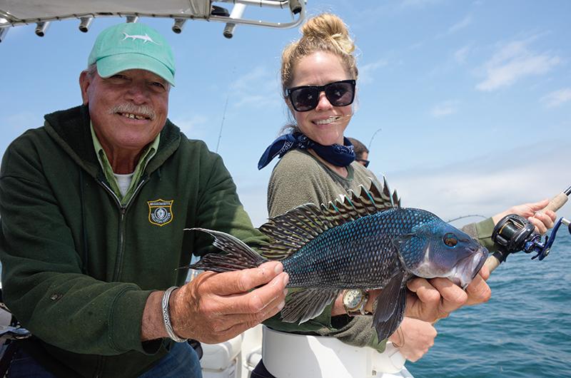 Buddy Vanderhoop and Erin Ryerson with a freshly caught black sea bass.