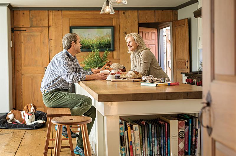 Daniel and Ellen Pesch and their dog, Bosun, in the kitchen of their Chilmark home.