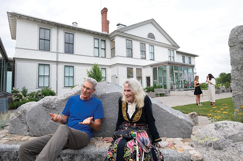 French and Kate Taylor sitting in front of the museum on a stone bench that forms the perimeter of the installation.