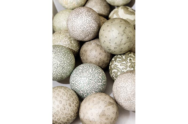 Collection of small spheres (ink and watercolor on paper over wood).