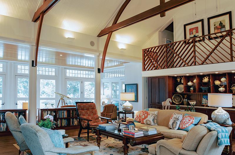 A sun-soaked solarium with large glass doors filters light into the house.