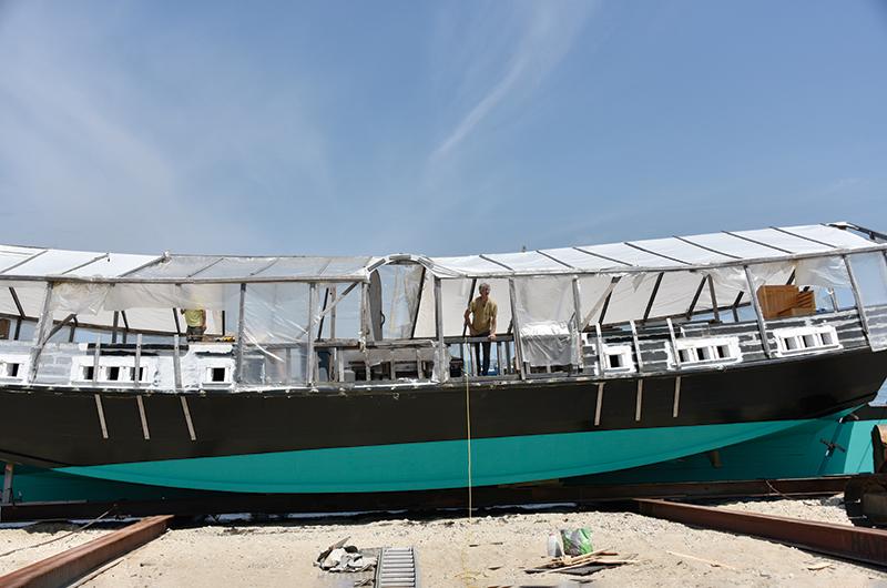 Over seven years at two locations along Vineyard Haven Harbor, Ted Box (pictured here in July 2018) built the massive scow.