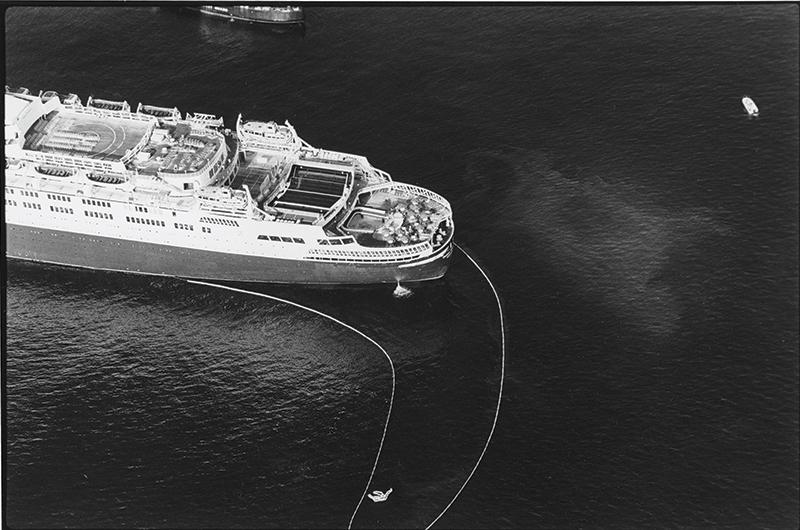 Booms were swung from the stern to contain oil spills, such as the patch seen outside the containment area, at right.