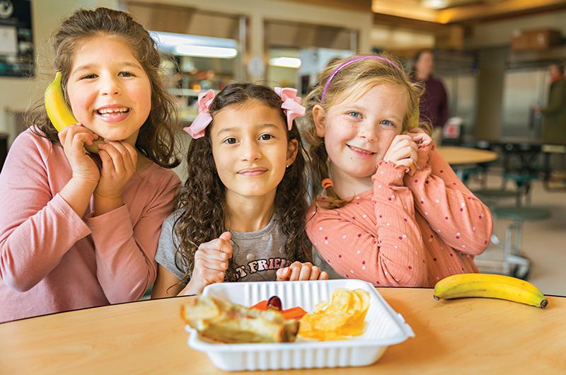 First-graders Bea, Electra, and Ada enjoy playing with their food almost as much as eating it.