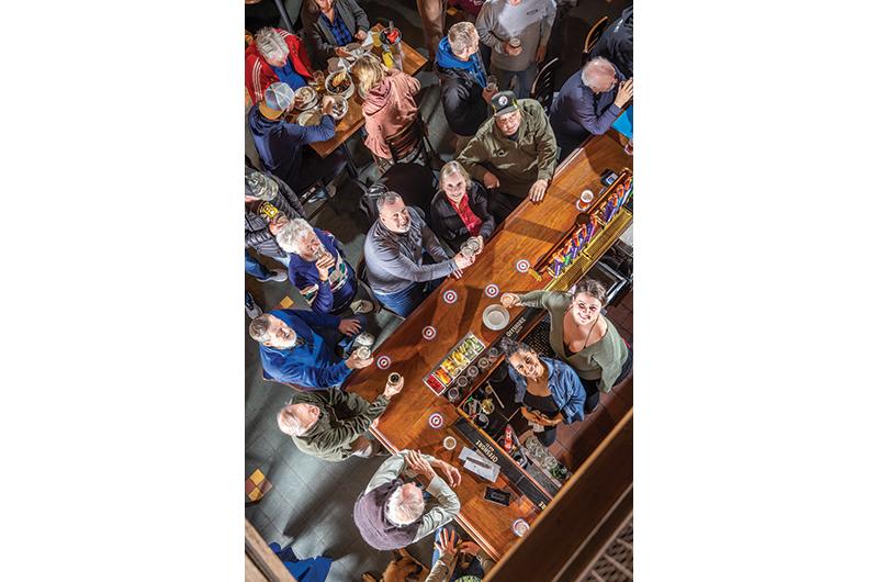Owners Bill and Susan Honeycutt (top left) keep the good vibes and craft brews flowing at Offshore Ale Co.