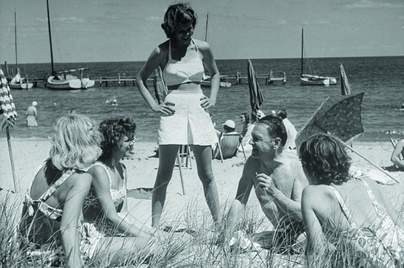 “Admirers invariably surround him,” Life magazine’s original caption for the photo above read, “sometimes girls...more often elderly ladies who try unsucessfully to corral him for dinner or cocktails.”